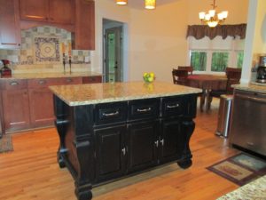 Black kitchen island completed by back chairs 3
